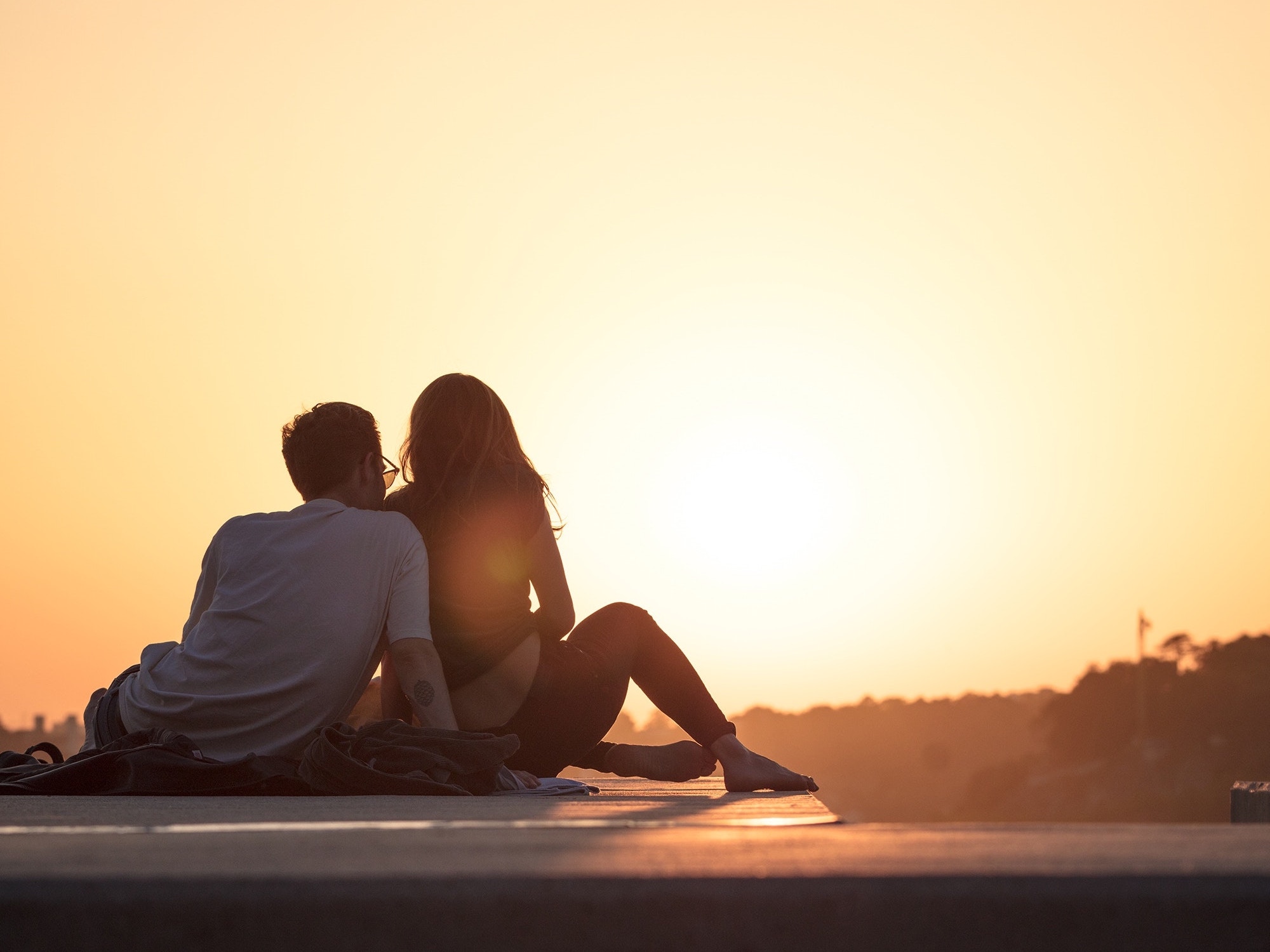 Couple posing in front of new house